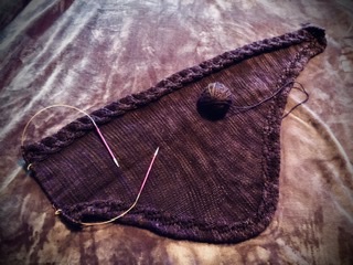 Knitting in the making of a Botany Kerchief in deep purple